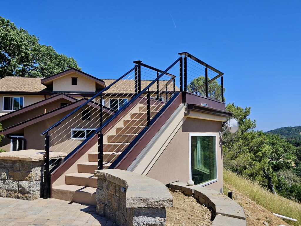 Custom outdoor metal hand railing with cable details by J&M Welding Inc., providing stylish and durable safety solutions for residential and commercial staircases in San Luis Obispo.