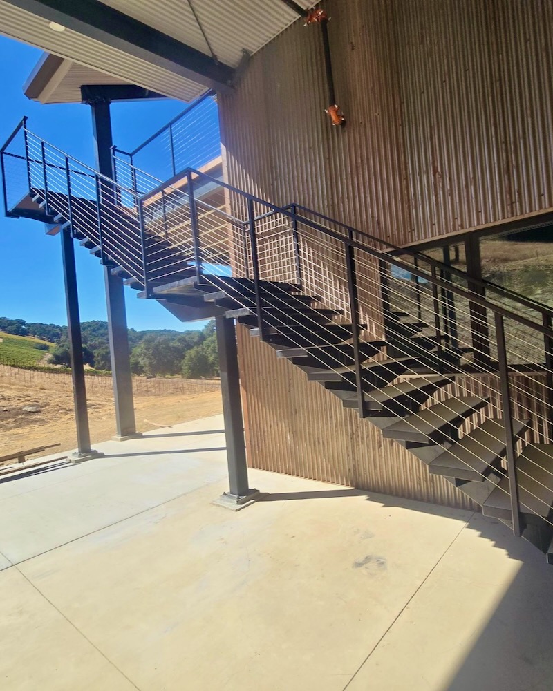 custom fabricated metal staircase with custom handrails completed at winery.