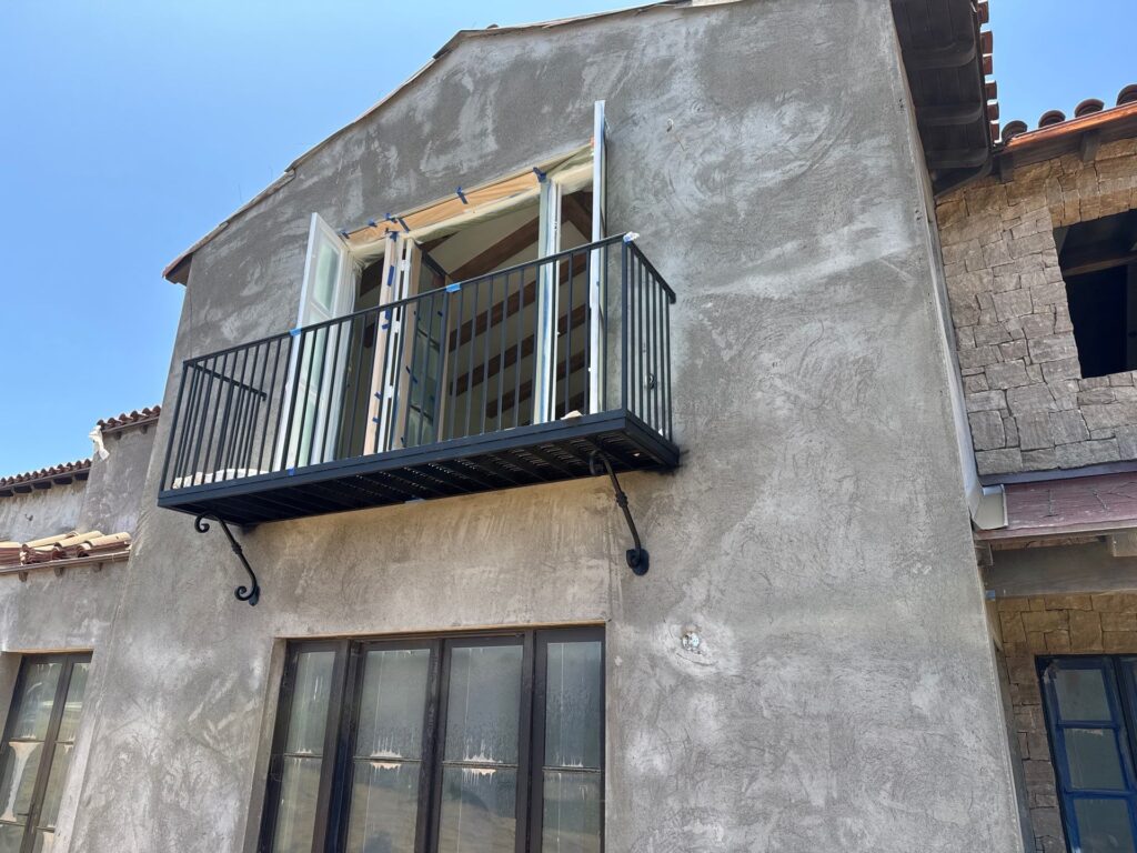 Wide view of completed custom steel balcony installed on a new residential build in Santa Barbara, California
