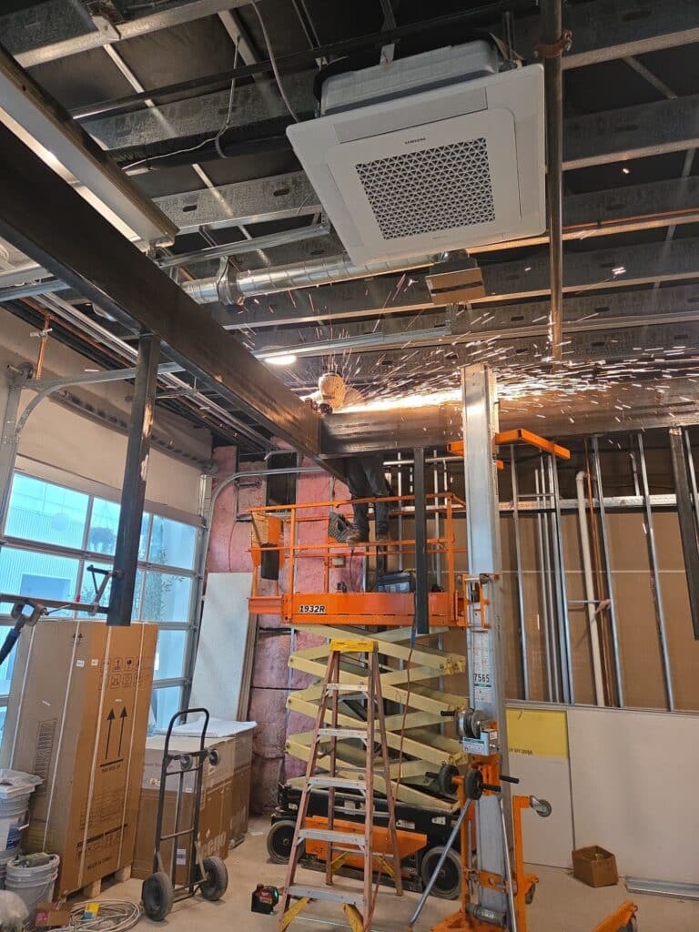 Structural steel installation in progress during Paso Robles restaurant remodel, with onsite welding and field adjustments inside open ceiling framing